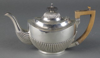 A Victorian silver batchelor's teapot with demi-fluted decoration and fruitwood mounts, Maker John Gammage Birmingham 1900, 235 grams
