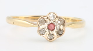 An 18ct yellow gold ruby and diamond cluster ring size O 