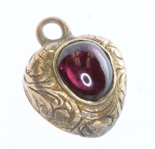 A Victorian gold heart shaped pendant with cabochon cut garnet 