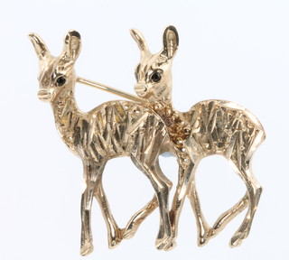A 9ct yellow gold brooch in the form of 2 deer with sapphire eyes, 5.4 grams
