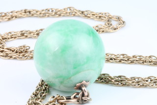A 22mm jade bead suspended on a 9ct chain