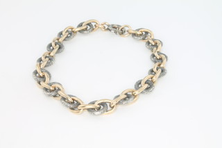 A yellow gold and silver chain bracelet 