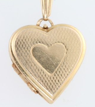A 9ct yellow gold engine turned locket 3.1 grams 