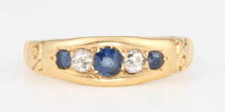 An 18ct yellow gold sapphire and diamond ring, size L 1/2 