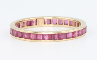 A 14ct yellow gold ruby set eternity ring size P 1/2 