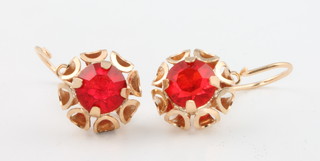 A pair of 14ct yellow gold red gem set ear clips 