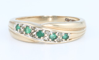 A 9ct yellow gold emerald and diamond twist ring size N 