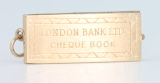 A 9ct yellow gold novelty charm in the form of a cheque book 2.6 grams