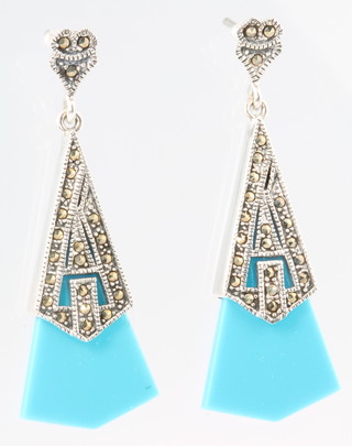A pair of turquoise set ear drops