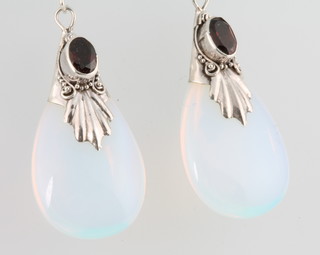 A pair of moon stone style ear drops