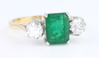 An 18ct yellow gold emerald and diamond 3 stone ring, the rectangular emerald 1.25ct flanked by brilliant cut diamonds each 0.3ct size O  