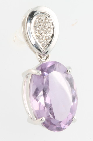 A 9ct white gold amethyst and diamond pendant