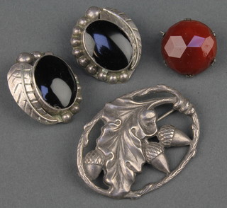 A silver repousse floral brooch and 3 other brooches