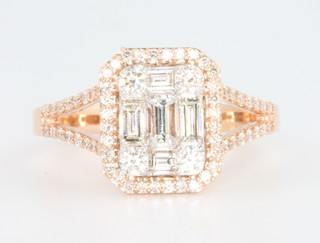 An 18ct rose gold diamond ring with 4 baguettes surrounded by brilliant cut stones 1.11ct, size O 