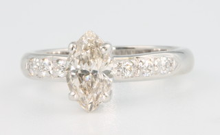 An 18ct white gold diamond ring, the marquise cut stone approx. 1.03ct with 3 brilliant cut diamonds to each shoulder, size M 