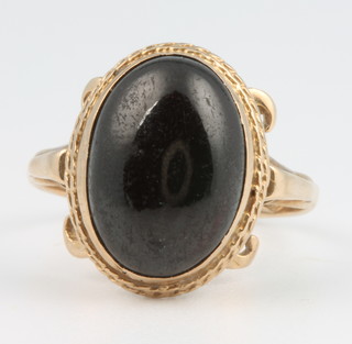 A yellow gold cabochon cut garnet ring size O