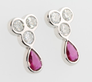 A pair of 18ct white gold ruby and diamond ear drops with pear cut rubies and brilliant cut diamonds, rubies approx. 0.83ct, diamonds approx. 0.99ct 
