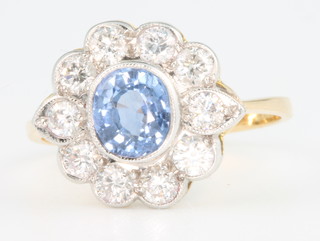 An 18ct yellow gold sapphire and diamond cluster ring, the centre stone approx. 0.80ct surrounded by brilliant cut diamonds approx. 1.3ct size O 
