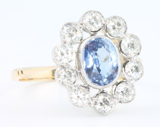 An 18ct yellow gold sapphire and diamond cluster ring, size O