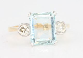 An 18ct yellow gold aquamarine and diamond ring, the centre stone approx. 2ct flanked by brilliant cut diamonds size N 