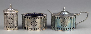 A Georgian style silver 3 piece condiment set with pierced decoration comprising mustard, salt and pepper with blue glass liners, Makers A Chick & Sons  London 1961 322 grams