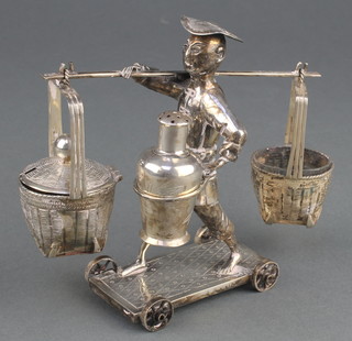 A Chinese white metal condiment in the form of a man carrying 2 baskets and a vase on a wheeled trolley 142 grams