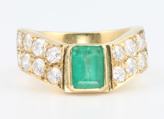 An 18ct baguette cut emerald and diamond ring size M 