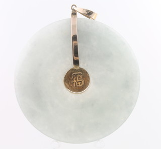 A 14ct yellow gold mounted circular jade pendant  