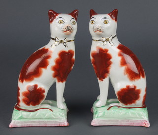 A pair of Staffordshire style figures of cats sitting on cushions 7" 