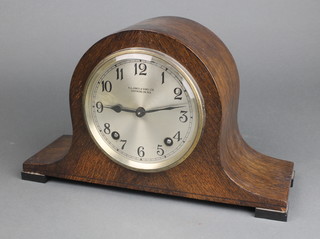 A 1930's striking mantel clock with silvered dial and Arabic numerals contained in an oak Admiral's hat shaped case, dial marked R A Jones & Sons Ltd Southend on Sea 