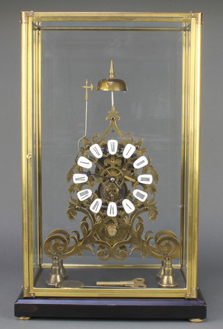 A Victorian style fusee brass skeleton clock with enamelled numerals contained in a gilt and glass case 21" x 12" x 8" 