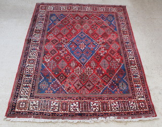 A blue and red ground Persian Joshagan rug with central medallion 118" x 89"