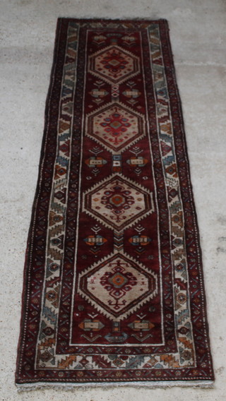 A white and brown ground Persian Nahavand runner with 4 diamonds to the centre 131" x 40" 