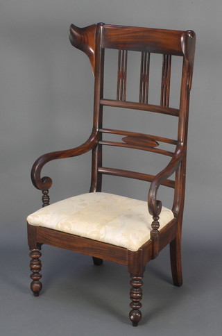 An Art Nouveau mahogany lambing style ladder back open arm chair with upholstered drop in seat, raised on turned supports 