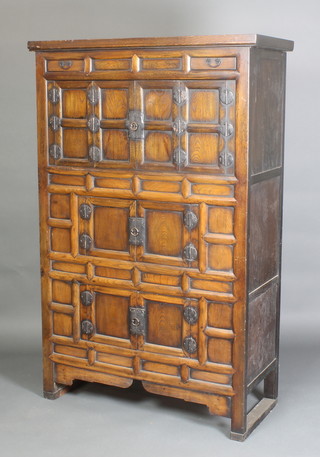A Chinese hardwood cabinet of panelled construction fitted 2 short drawers above 3 cupboards enclosed by double panelled doors, 65"h x 42"w x 18"d 