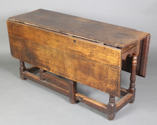 A 17th/18th Century oak rectangular drop flap gateleg dining table, raised on turned and block supports 29 1/2"h x 55"w x 18 1/2" when closed x 51 1/2"w when open 