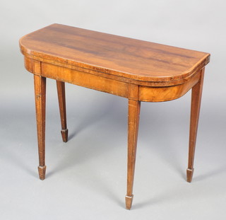 A Georgian mahogany D shaped folding card table with crossbanded top raised on square tapering supports, spade feet 28 1/2"h x 36"w x 18"d 