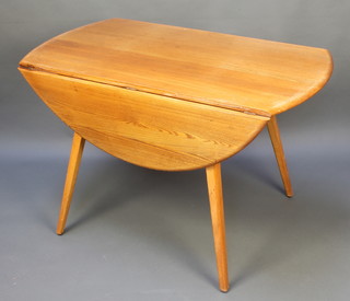 An Ercol Windsor style oval drop flap table, raised on outswept supports 28"h x 44" x 24" when closed x 48" when open 