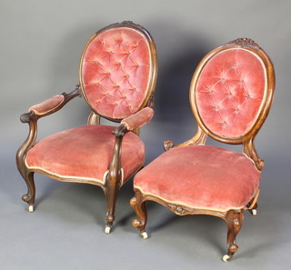 A Victorian carved mahogany open arm chair with carved cresting rail upholstered in pink material together with a similar hoop back chair