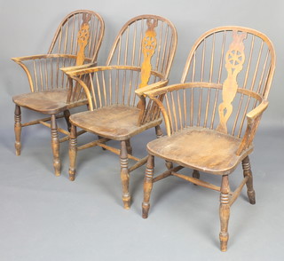 A set of 3 19th/20th Century elm stick and wheel back armchairs with solid seats on turned supports with H framed stretchers 