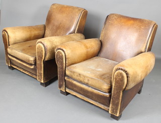 A pair of club style armchairs upholstered in worn leather 