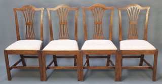 A set of 4 19th Century oak Hepplewhite style dining chairs with vase shape slat backs  and upholstered seats raised on square supports with H framed stretchers 