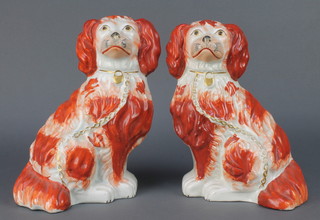 A pair of Victorian Staffordshire spaniels with ochre decoration 10" 