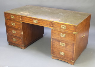 A mahogany military style desk with green  leather inset writing surface above 1 long and 8 short drawers with brass banding and counter sunk handles, raised on bracket feet 29 1/2"h x 60 1/2"w x 30 1/2"d 