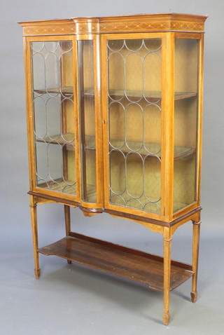 An Edwardian inlaid mahogany display cabinet with shaped cornice enclosed by lead glazed panelled doors, raised on square tapered supports with undertier 67 1/2"h x 44 1/2"w x 15"d 