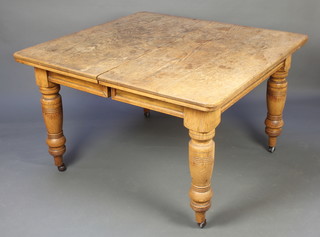 A Victorian light oak rectangular extending dining table, raised on turned supports with 1 extra leaf 29 1/2"h x 45"w x 47 1/2" x 65 1/2" with extra leaf 