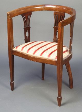 An Edwardian mahogany tub back chair with upholstered drop in seat raised on square tapering supports ending in spade feet 