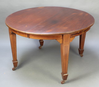 An Edwardian oval inlaid mahogany extending dining table with 2 extra leaves, raised on 4 square tapered supports, spade feet 28"h x 47"w x 47 1/2"l  x  with the leaves 94 1/2"l  