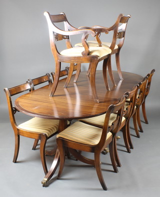 A Georgian style mahogany dining suite comprising triple pillar D end extending dining table with 2 extra leaves inlaid with brass crossbanding 29"h x 38 1/2"w x 90 1/2"l  x 133 1/2"l with leaves  together with 10 bar back dining chairs - 8 standard, 2 carvers