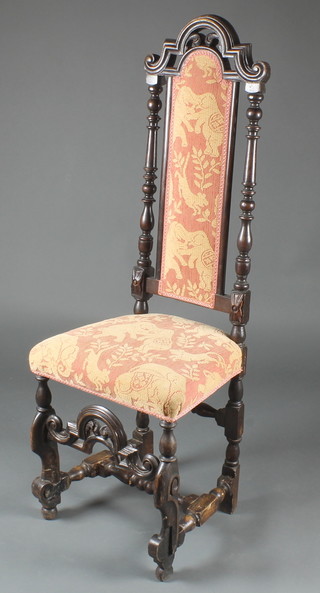 A Carolean carved oak high back chair with upholstered seat and back, raised on carved supports with H framed stretcher 